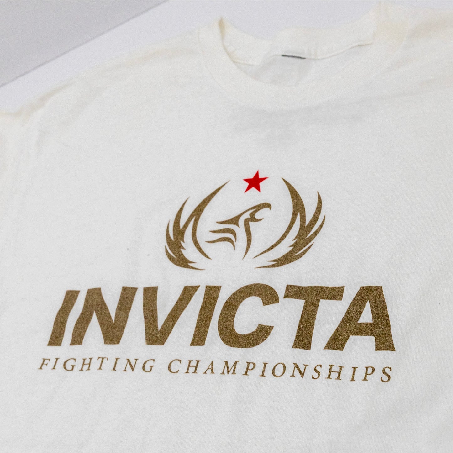 Titled Angle Logo view of White Invicta Legacy Tee
